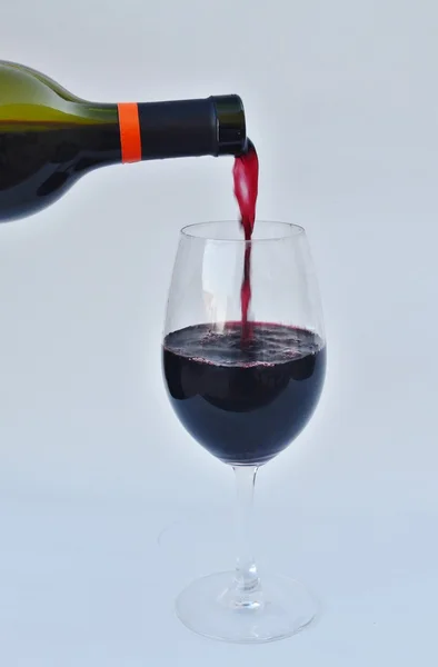 Red wine being poured into a glass — Stock Photo, Image