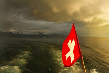 Swiss flag on boat. Lake Leman clipart