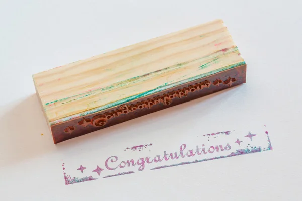 Congratulation stamped on paper — Stock Photo, Image