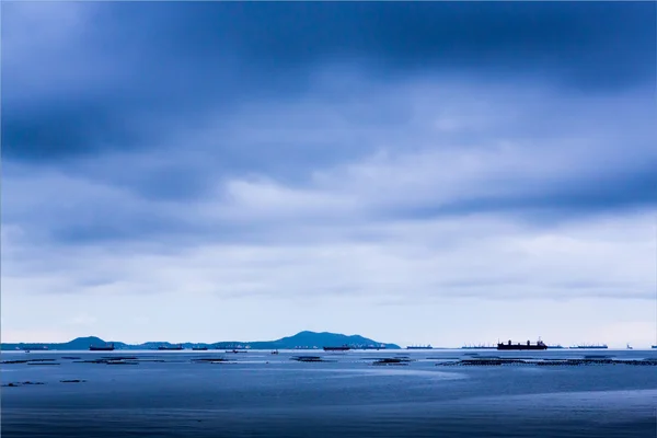 Blue cloudy sea with big ships — Stock Photo, Image