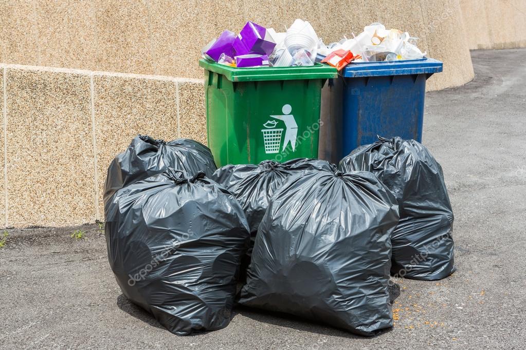 Trash bin and black garbage bag Stock Photo by ©smuayc 31845137