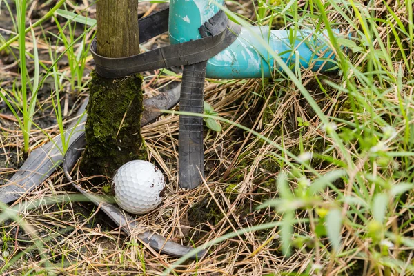 Bola de golfe perto do tubo de água guia — Fotografia de Stock