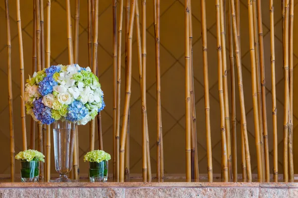 Flower bouquet and bambook sticks — Stock Photo, Image