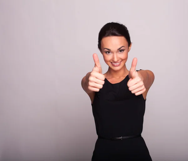 The happy young woman showing thumbs up sign — Stock Photo, Image
