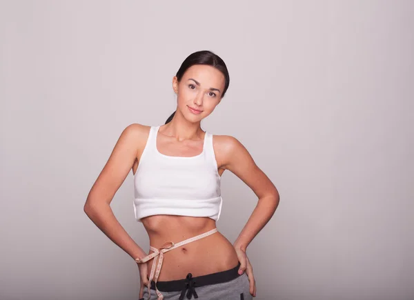 Woman measuring her waist looking very happy — Stock Photo, Image