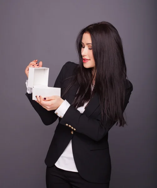 A girl holding a white box with a gift — Stock Photo, Image