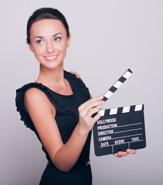 woman holds an open film slate