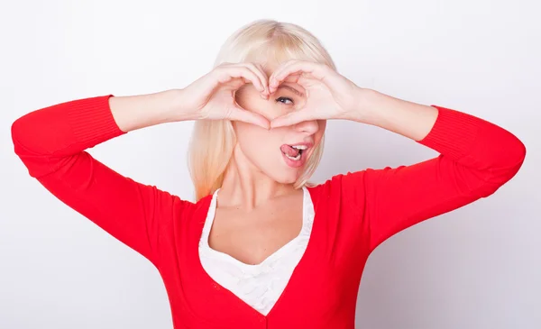 Blonde girl made heart and smiles — Stock Photo, Image