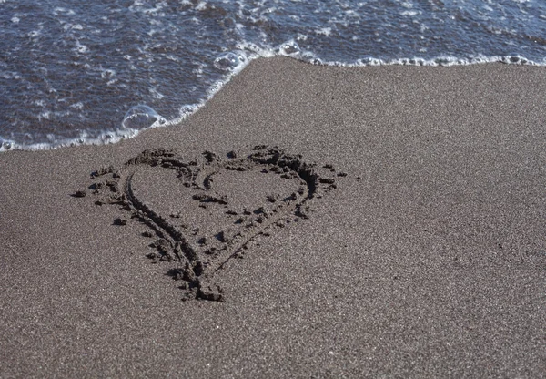 Heart drawn on sand Stock Photo