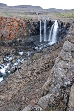 Landscape with rocks and a waterfall.