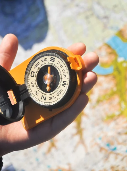 Compass under the sun on the palm — Stock Photo, Image