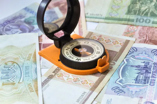 Banknotes and compass. Navigation in the world of Finance.