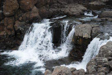 Landscape with rocks and a waterfall.