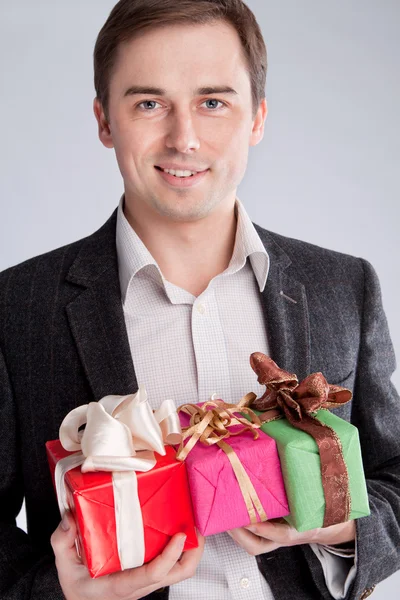 Portrait of a man in a suit with gifts — Stock Photo, Image