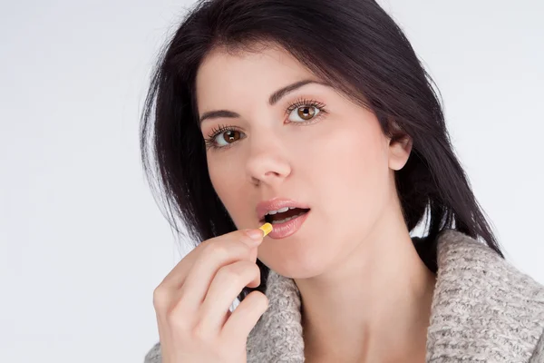 Portrait of a girl looking directly into the mouth and lodge capsule — Stock Photo, Image