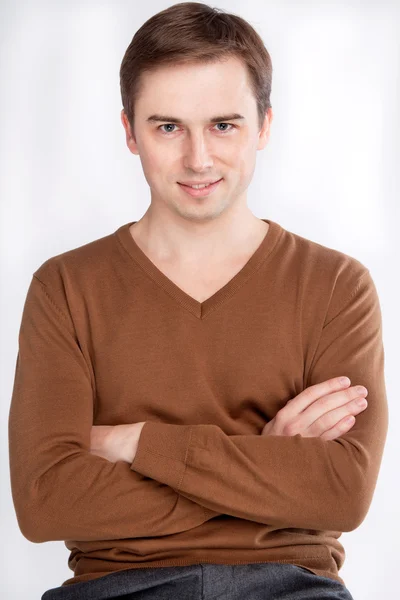 Portrait of a man looking straight, hands folded on his chest — Stock Photo, Image