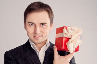 Guy holding a gift near the face, look intriruyuschy (retro) clipart