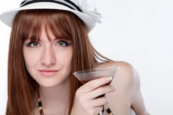 Girl in a hat holding a glass of martini near face — Stock Photo, Image
