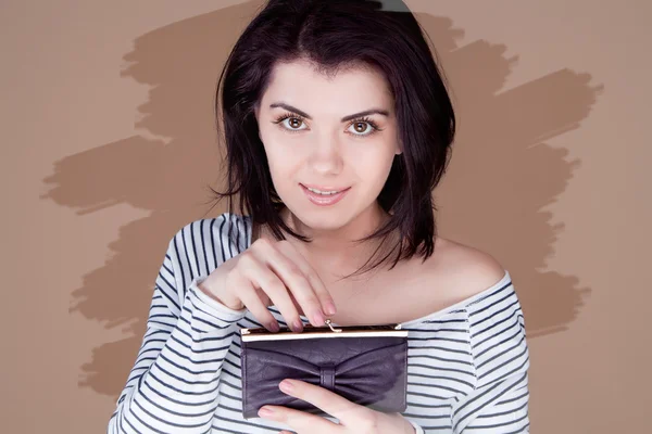 Menina segura na frente de uma carteira aberta sorrindo, tonificação incomum — Fotografia de Stock