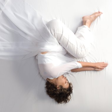 Woman in fetal position on white background clipart