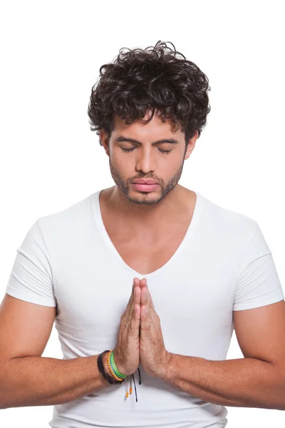 Ung man med händer i bön — Stockfoto
