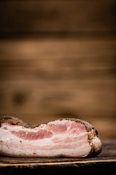 A piece of delicious pork fat lard. On a wooden background. High quality photo