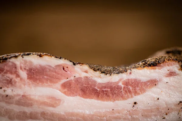 A piece of delicious pork fat lard. On a wooden background. High quality photo