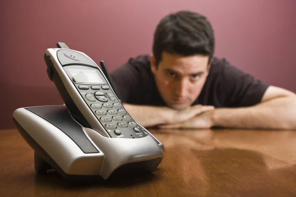 Man bored waiting for the phone to ring — Stock Photo, Image