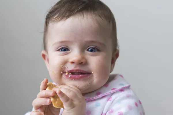 Rendetlen, boldog kislány enni egy süti — Stock Fotó