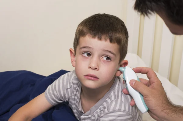 Sick boy gets his temperature taken — Stock Photo, Image