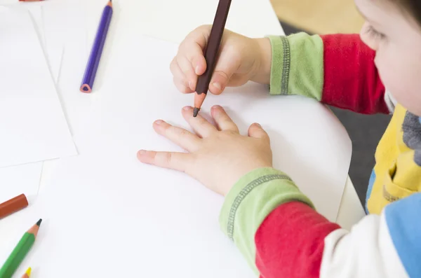 Toddler about to draw an outline of his hand — Stock Photo, Image