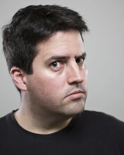 Man stares suspiciously at the camera — Stock Photo, Image