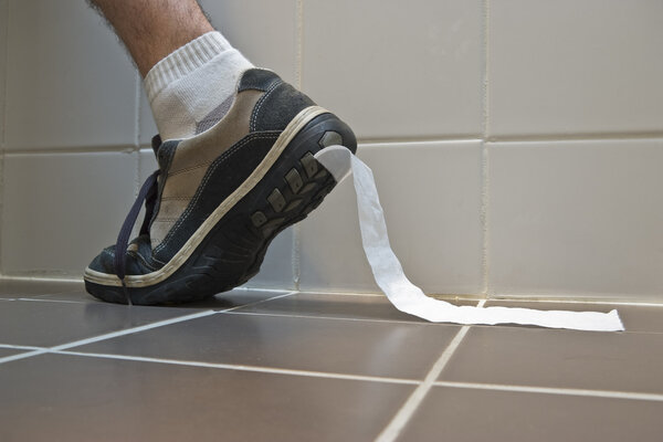 Toilet paper stuck to sports shoe.