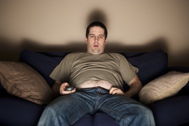 Overweight slob watching TV clipart