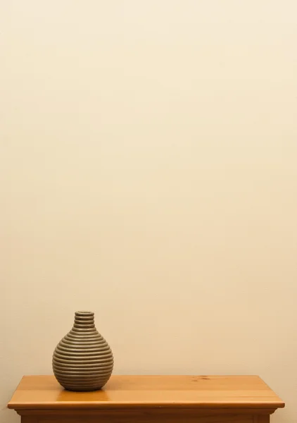 Short striped vase on table — Stock Photo, Image