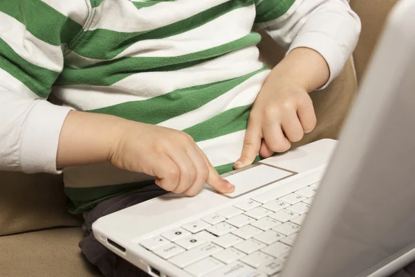 Young boy uses touchpad on NetBook laptop — Stock Photo, Image