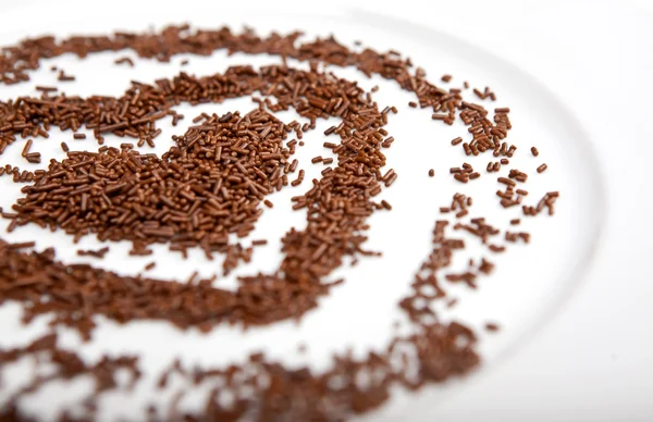 Heart of chocolate chips on a white plate porcelain — Stock Photo, Image