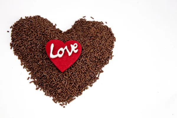 Red heart on big heart of piece of chocolate — Stock Photo, Image