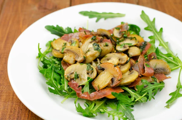 Champiñones con jamón ahumado y ensalada de rúcula —  Fotos de Stock