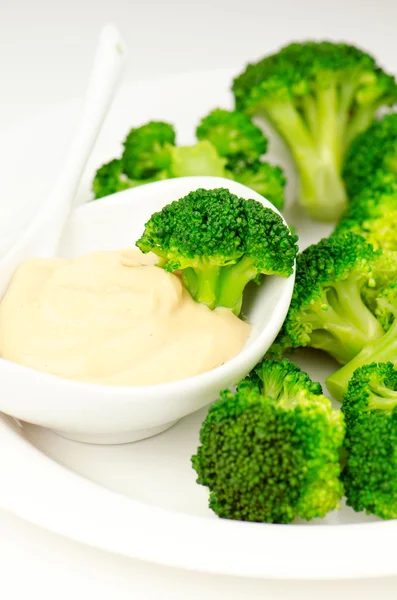 Broccoli with sauce — Stock Photo, Image