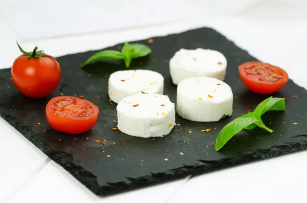 Goat cheese with cherry tomatoes — Stock Photo, Image