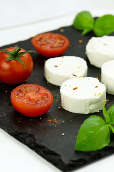 Goat cheese with cherry tomatoes — Stock Photo, Image