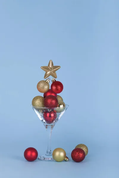 Минимальная Идея Рождественской Вечеринки Коктейльный Бокал Рождественскими Шариками Синем Фоне — стоковое фото
