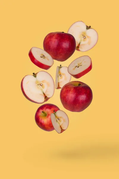 最小的水果想法与新鲜的切片和整个苹果漂浮在空气中隔离在油腻的黄色背景 维生素 健康饮食的概念 有飞果的创意概念 — 图库照片