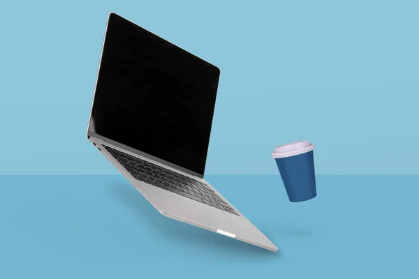 Laptop Mit Leerem Bildschirm Und Pappbecher Mit Der Luft Schwebendem — Stockfoto