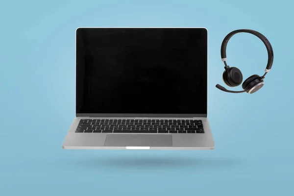 Laptop Computer Empty Screen Headset Levitating Air Bright Blue Background — Stockfoto
