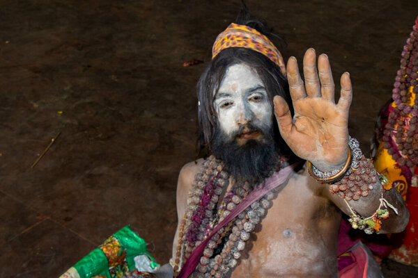 Naga sadhu in blessing posture