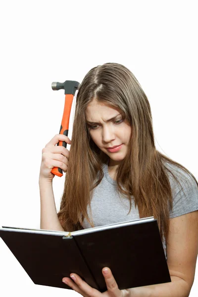 Joven constructora con martillo leyendo un manual — Foto de Stock