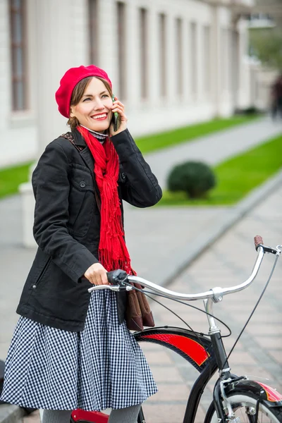 Ciclismo urbano. Mujer joven con bicicleta está hablando por teléfono. Gente activa. Aire libre, estilo de vida — Foto de Stock