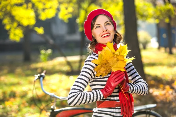 Schöne glückliche Frau lächelt im Herbstpark und hat Spaß an einem sonnigen Herbsttag lizenzfreie Stockfotos